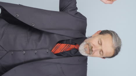 Vertical-video-of-Old-businessman-dancing-to-the-camera.